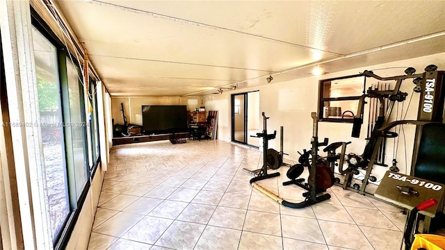 workout room featuring light tile patterned floors