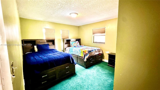 carpeted bedroom featuring a textured ceiling