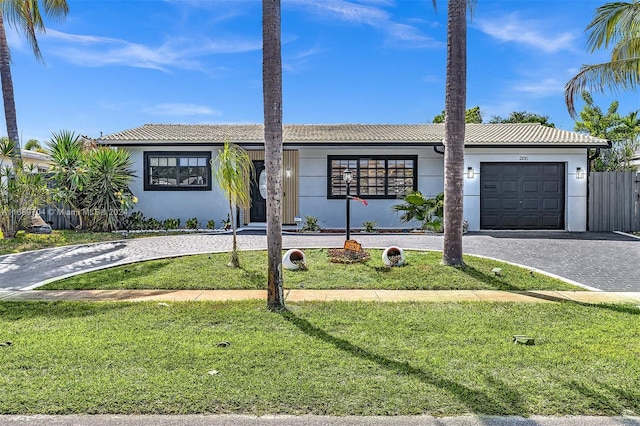 view of front of property with a front lawn and a garage