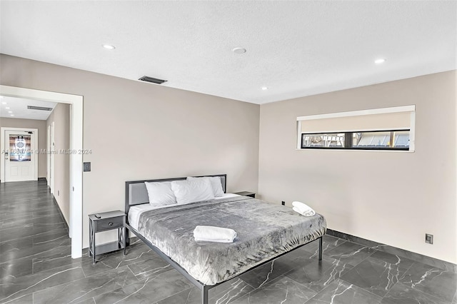 bedroom featuring a textured ceiling