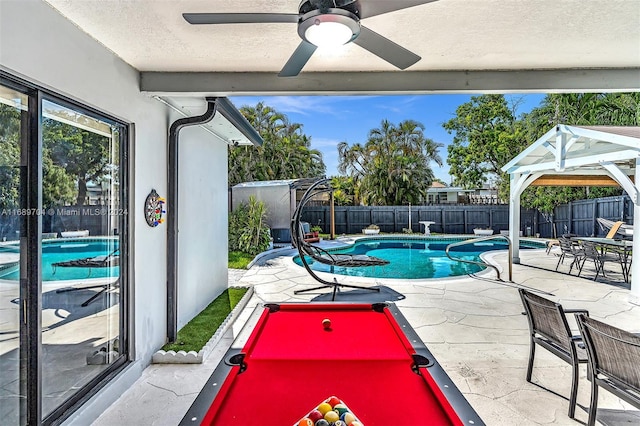 view of pool with a patio area and ceiling fan