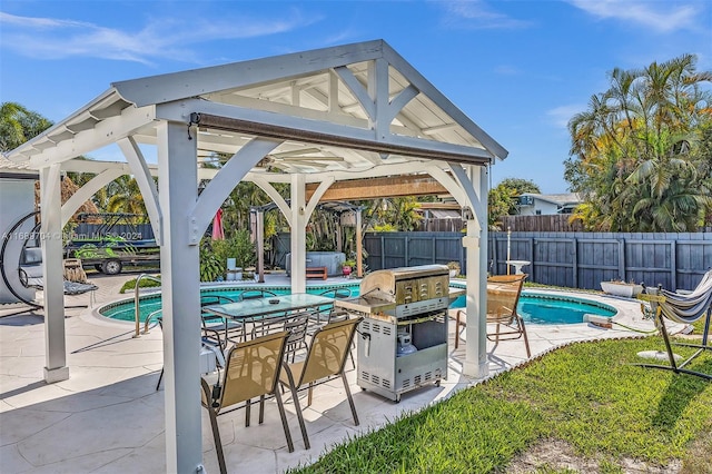 view of swimming pool featuring a patio area, a gazebo, and grilling area