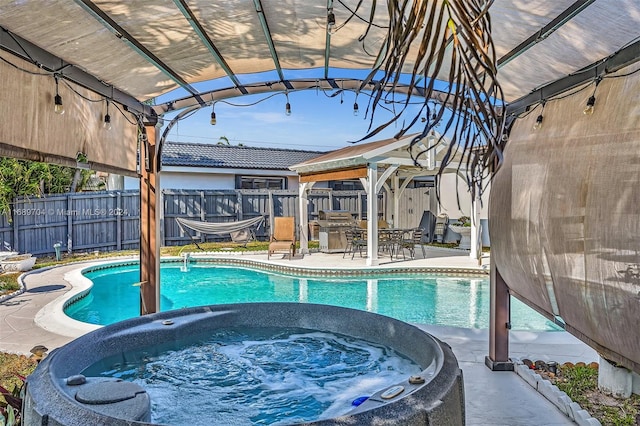 view of pool with a gazebo, an outdoor hot tub, and a patio area