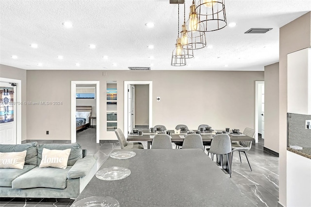 dining room with a textured ceiling and an inviting chandelier