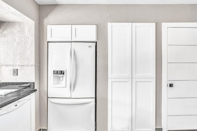 kitchen with white cabinetry and white appliances