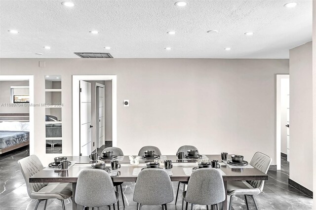 dining room with built in shelves and a textured ceiling