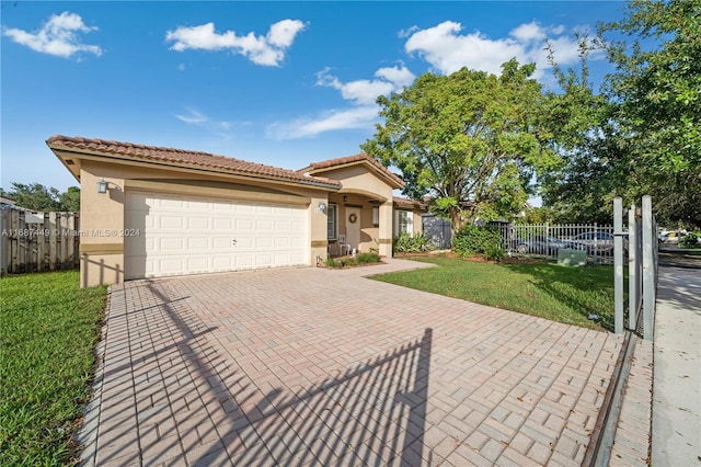 view of front of house with a front yard and a garage