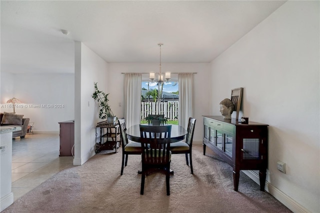 dining area with light tile patterned floors and a notable chandelier