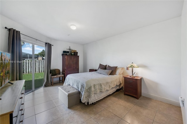 bedroom featuring light tile patterned flooring and access to outside