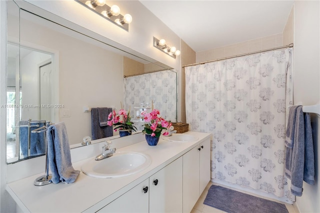 bathroom with tile patterned floors, vanity, and walk in shower