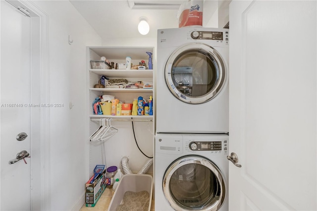 clothes washing area featuring stacked washer / drying machine