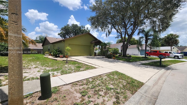 view of front of home with a garage and a front yard