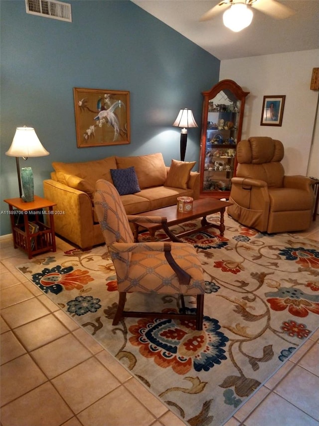 tiled living room with ceiling fan and vaulted ceiling