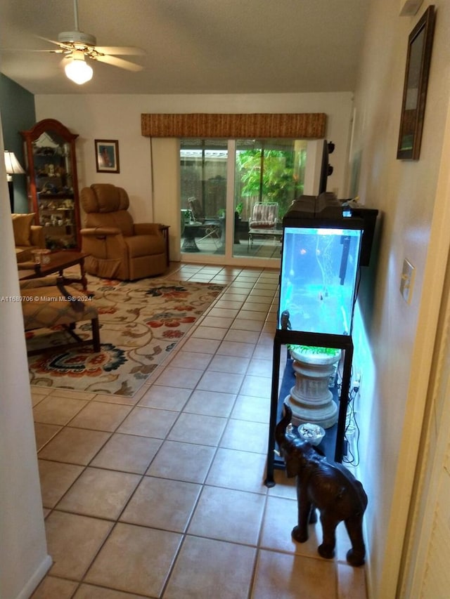 living room with ceiling fan and light tile patterned flooring