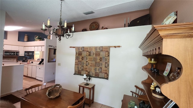 dining area with light tile patterned flooring, a textured ceiling, an inviting chandelier, and lofted ceiling