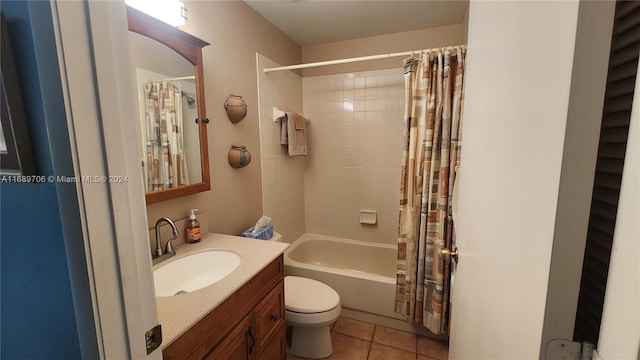 full bathroom featuring toilet, shower / bath combo, vanity, and tile patterned flooring