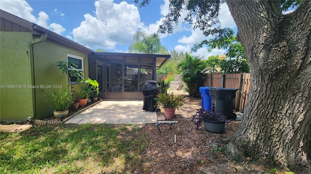 view of yard featuring a patio and a sunroom