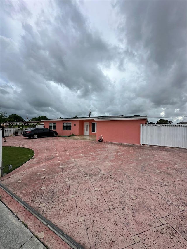 1250 W 61st Pl, Hialeah, FL 33012 - ranch-style house with a fenced front yard