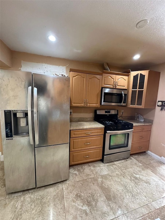 1250 W 61st Pl, Hialeah, FL 33012 - kitchen with appliances with stainless steel finishes, glass insert cabinets, baseboards, light countertops, and recessed lighting