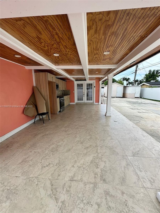 1250 W 61st Pl, Hialeah, FL 33012 - garage featuring a storage shed, french doors, baseboards, and wood ceiling