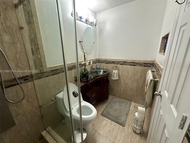 1250 W 61st Pl, Hialeah, FL 33012 - full bath featuring tile walls, a shower stall, toilet, vanity, and wainscoting