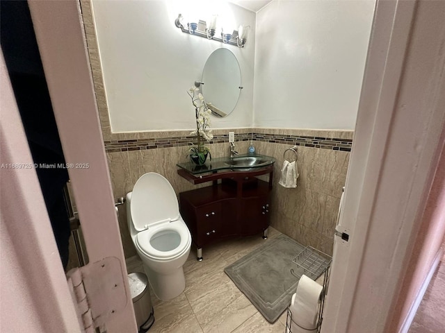 1250 W 61st Pl, Hialeah, FL 33012 - bathroom with tile walls, toilet, wainscoting, and vanity