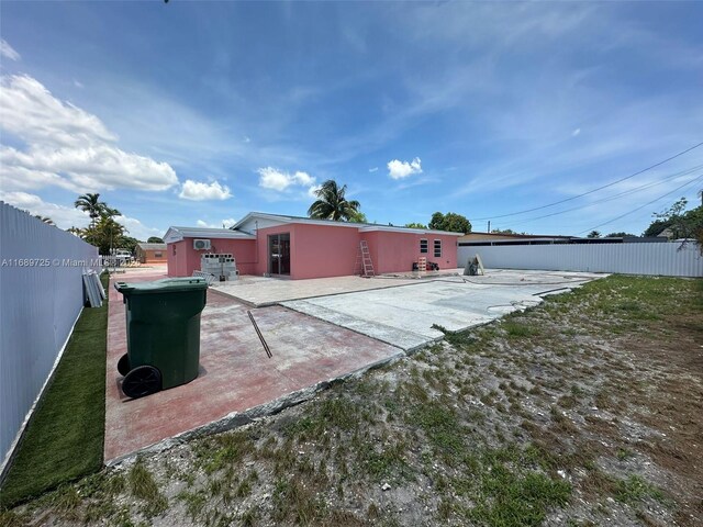 1250 W 61st Pl, Hialeah, FL 33012 - unfurnished bedroom with light tile patterned flooring, a closet, a textured ceiling, ensuite bathroom, and ceiling fan
