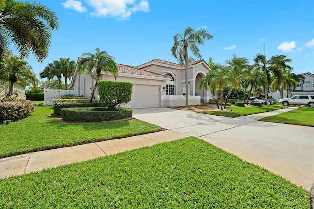 mediterranean / spanish-style house with a garage and a front yard