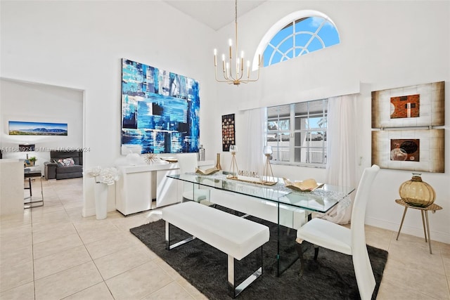 tiled dining space featuring high vaulted ceiling and an inviting chandelier