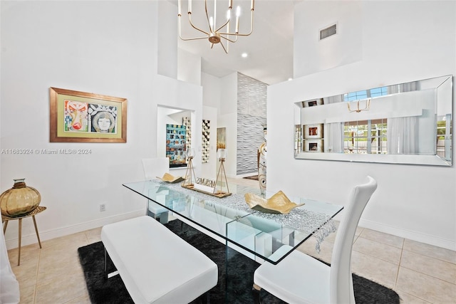 dining area featuring light tile patterned floors and a high ceiling