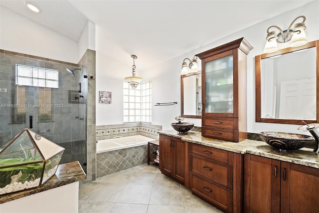 bathroom featuring tile patterned flooring, vanity, and separate shower and tub