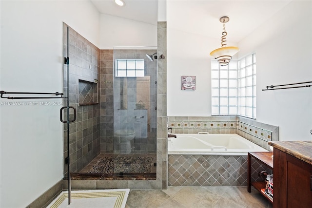 bathroom with vanity, lofted ceiling, tile patterned floors, and separate shower and tub