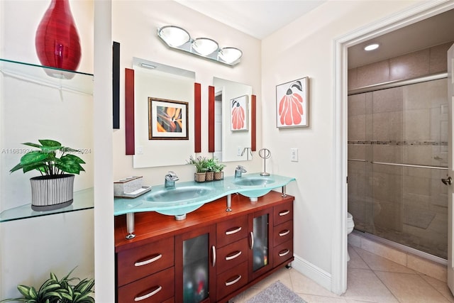 bathroom with vanity, a shower with shower door, tile patterned floors, and toilet