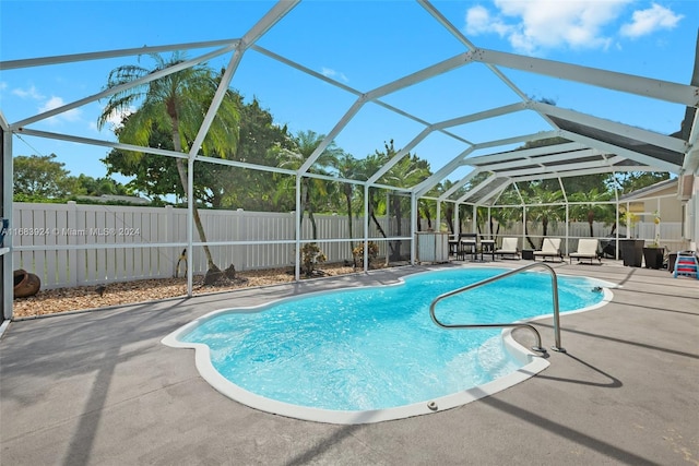 view of pool with a lanai and a patio