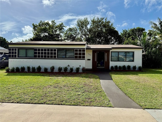 ranch-style house with a front lawn