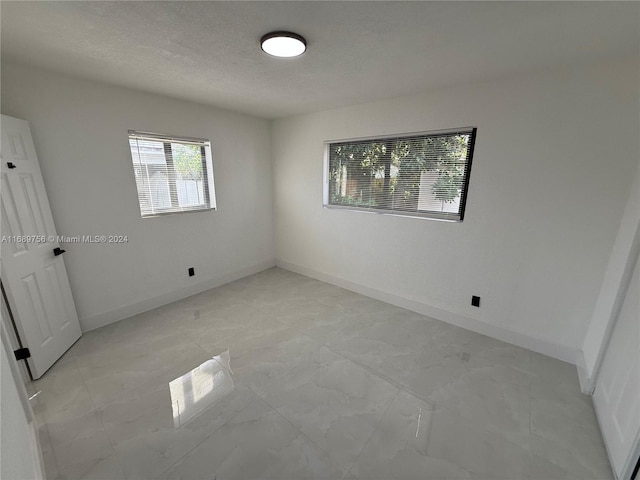 empty room with a textured ceiling