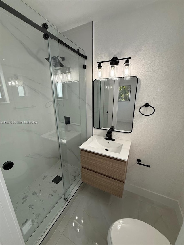 bathroom featuring vanity, toilet, and a shower with door