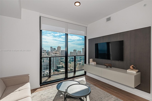 living room featuring hardwood / wood-style floors and a wall of windows