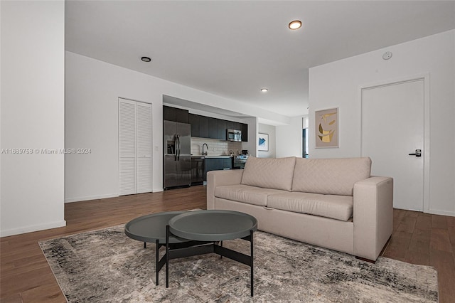 living room featuring dark hardwood / wood-style floors and sink