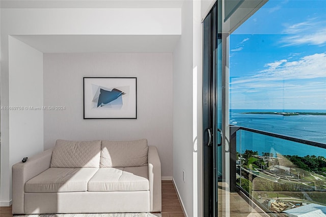 living room featuring a water view and hardwood / wood-style flooring