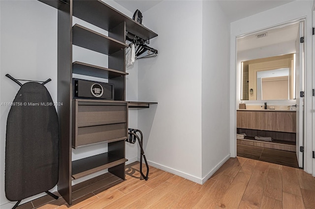 spacious closet with hardwood / wood-style flooring