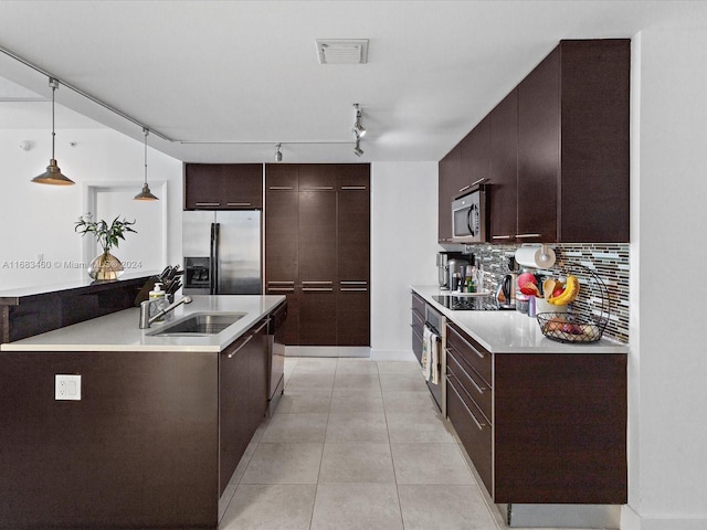 1900 N Bayshore Dr Unit 1704, Miami, FL 33132 - kitchen featuring black appliances, a sink, track lighting, dark brown cabinets, and decorative backsplash