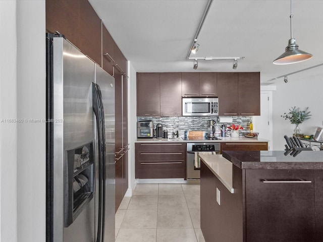 kitchen featuring pendant lighting, appliances with stainless steel finishes, and dark brown cabinetry