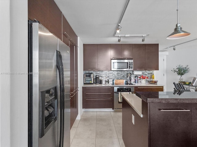1900 N Bayshore Dr Unit 1704, Miami, FL 33132 - kitchen with appliances with stainless steel finishes, backsplash, dark brown cabinetry, and light tile patterned floors