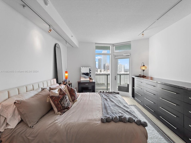 1900 N Bayshore Dr Unit 1704, Miami, FL 33132 - bedroom with access to outside, light wood-style floors, rail lighting, and expansive windows