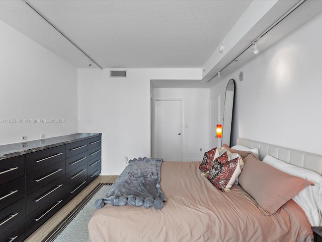 1900 N Bayshore Dr Unit 1704, Miami, FL 33132 - bedroom with track lighting, light wood-type flooring, and a textured ceiling