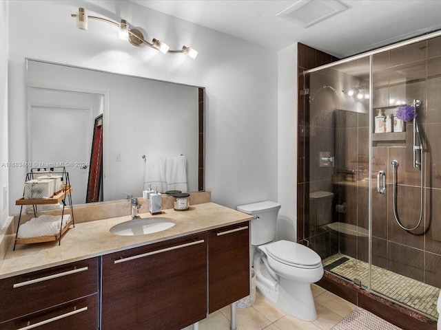 bathroom with toilet, vanity, tile patterned floors, and a shower with door