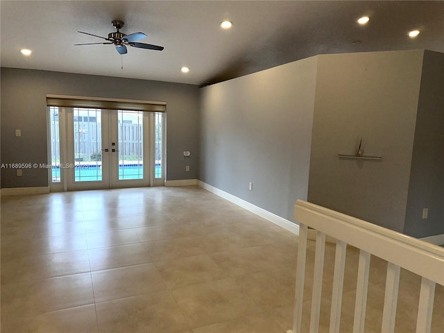 tiled empty room featuring french doors and ceiling fan