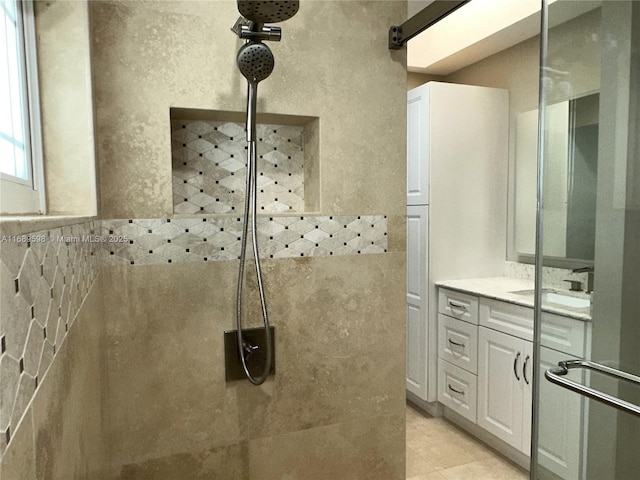 bathroom with vanity, tile patterned flooring, and walk in shower