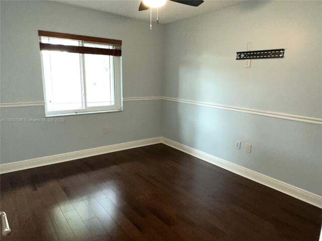 interior space with dark wood-type flooring, ceiling fan, and a closet